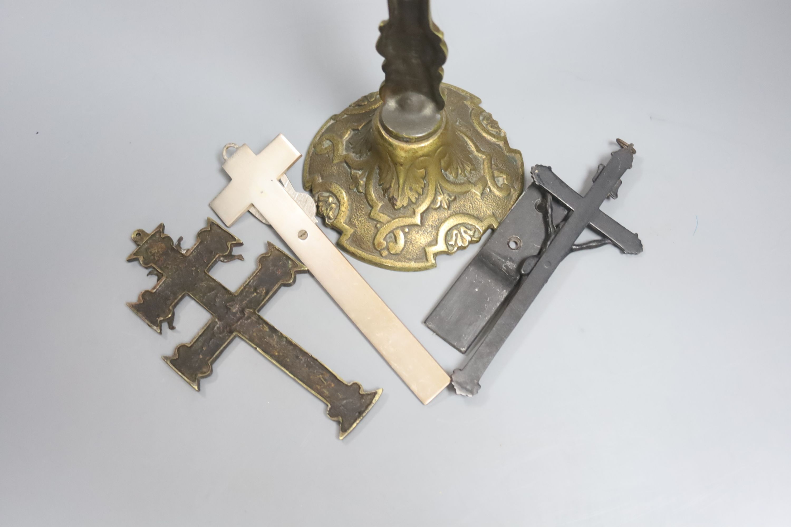 A group of four brass and metal crucifixes, largest 34cm